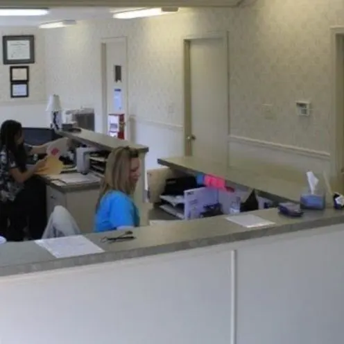 Two members of staff working at the front desk of Eastview Veterinary Clinic