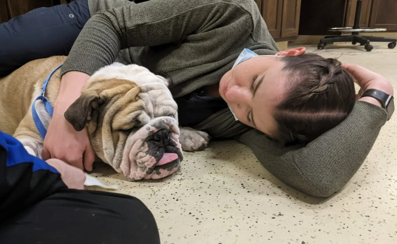 Woman Laying on the Floor Asleep with a Dog