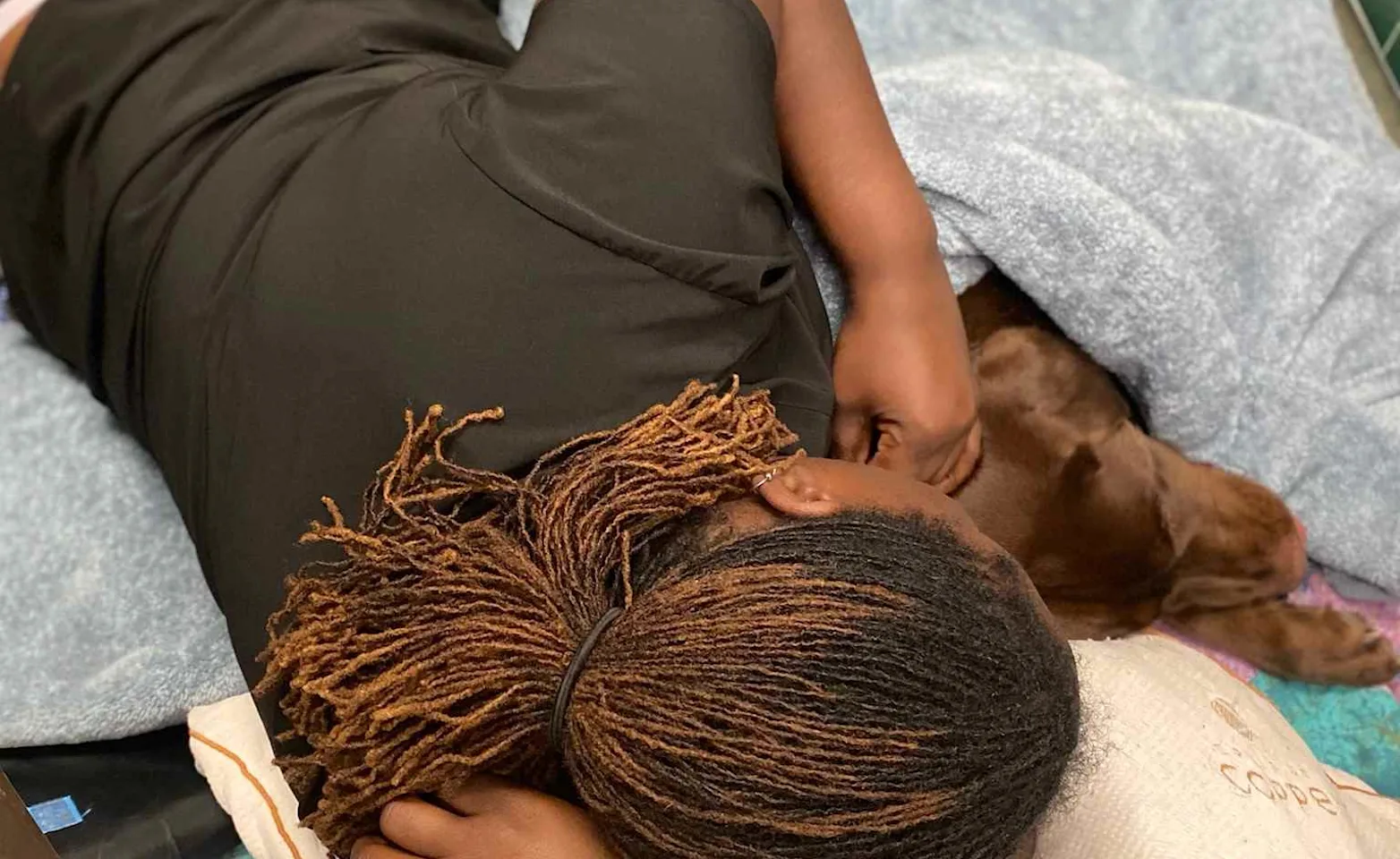 Staff member laying next to pet Staff member laying next to pet