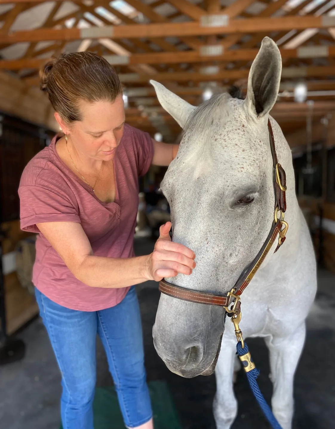 Photo of Jen King with a white horse Photo of Jen King with a white horse