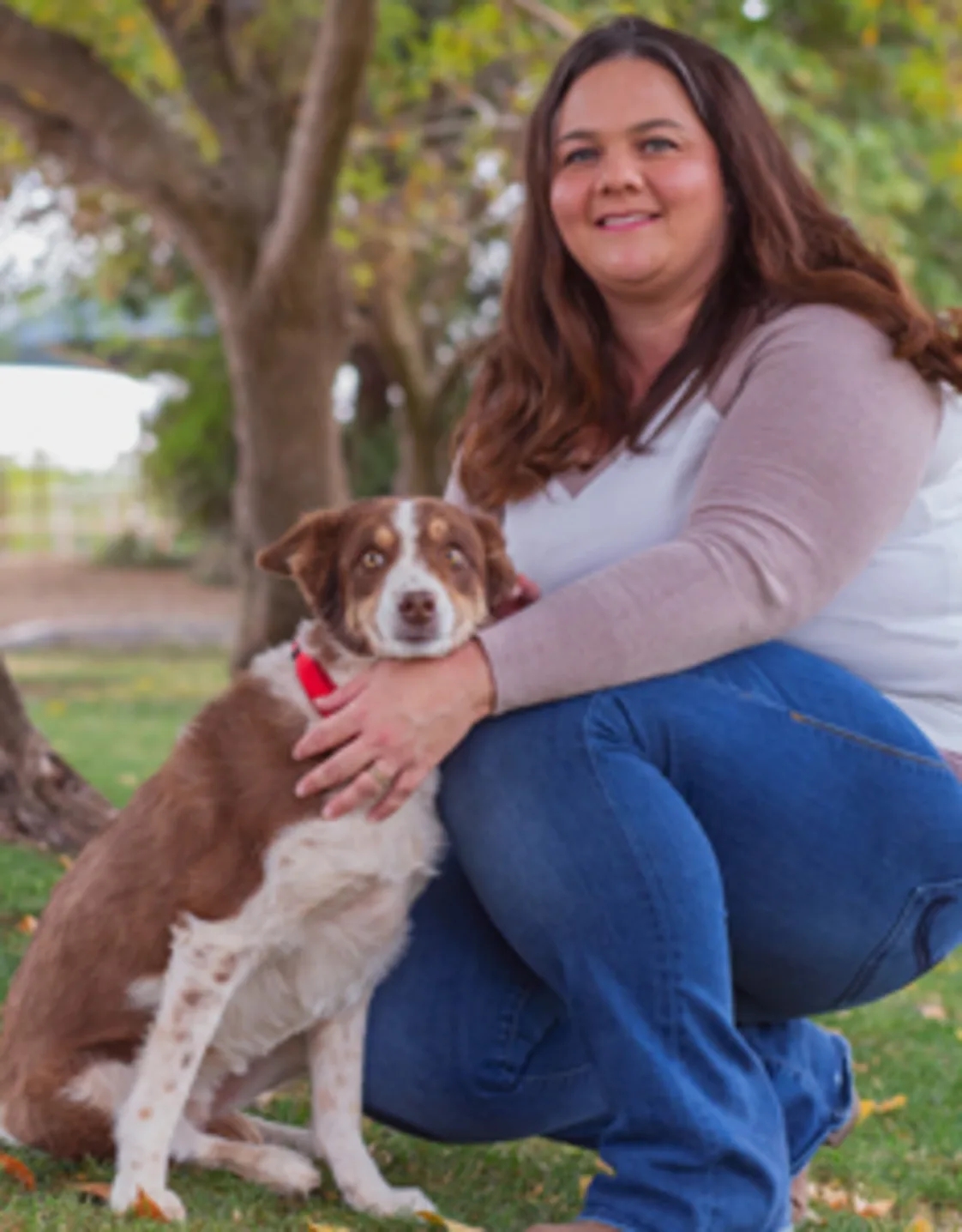 Nicolette Gamez kneeling next to a brown and white dog Nicolette Gamez kneeling next to a brown and white dog