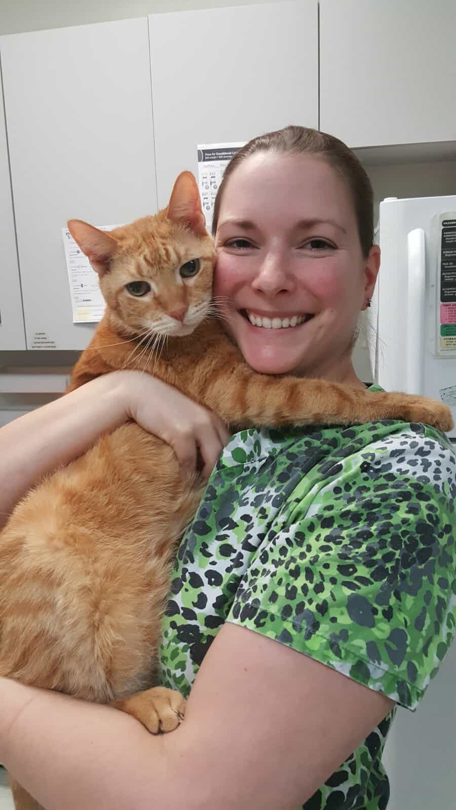 Staff member with orange cat