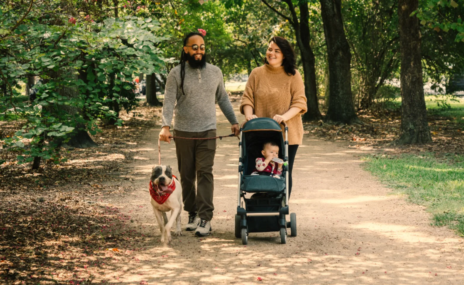 Parents and a child walking their dog Parents and a child walking their dog