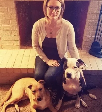 Jennifer Hawn, Hospital Manager at North Channel Animal Hospital, sitting with two dogs