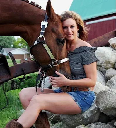 Tiffany from Midland Animal Clinic with a brown horse Tiffany from Midland Animal Clinic with a brown horse