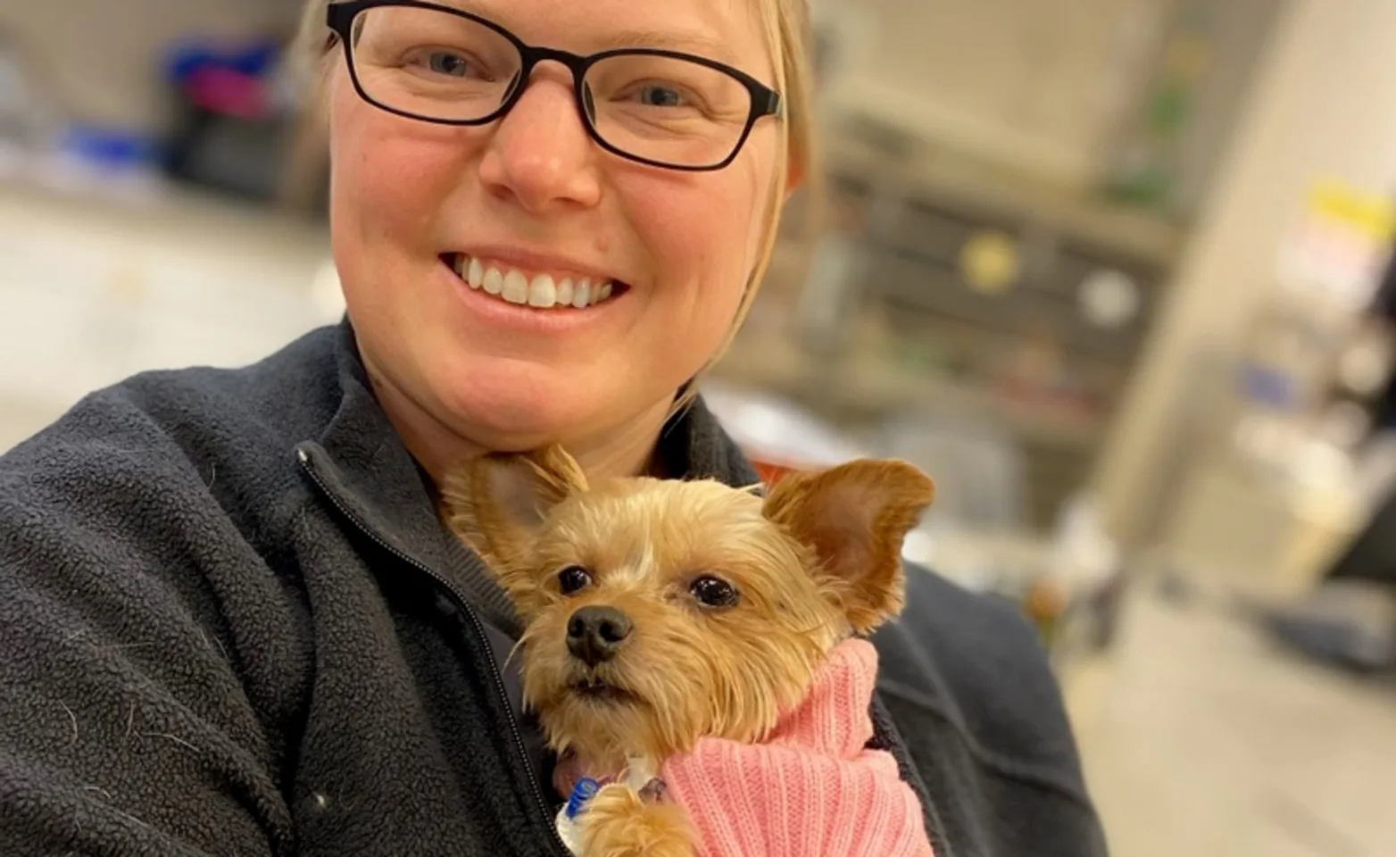 Woman holding brown puppy Woman holding brown puppy