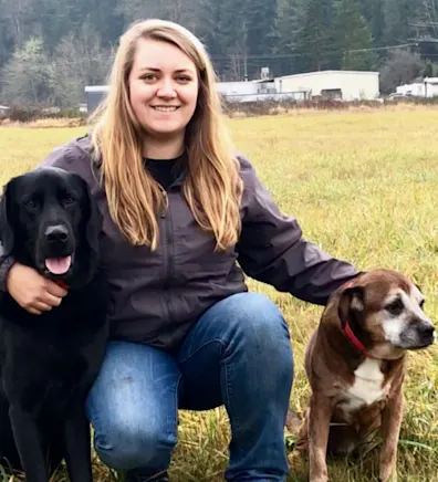 Darian with a black dog and brown and white dog