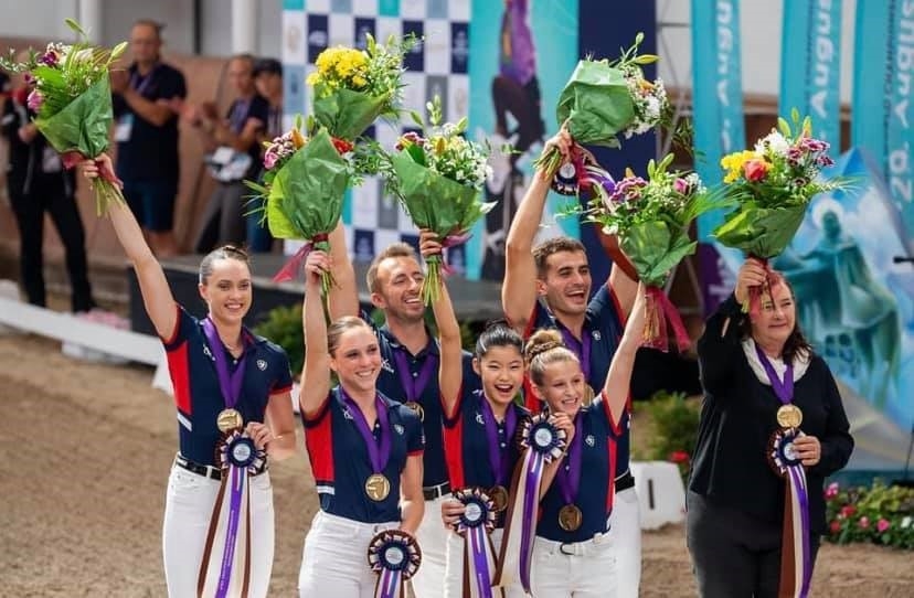 Horse Riding Champions Holding Awards & Flowers