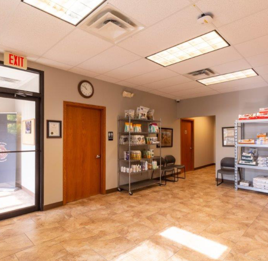 A photo of The welcoming lobby and waiting area at Dunes Animal Hospital, which has shelves stocked with animal food.