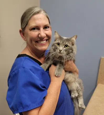 Trish Reidenbach holding a brindle gray cat Trish Reidenbach holding a brindle gray cat