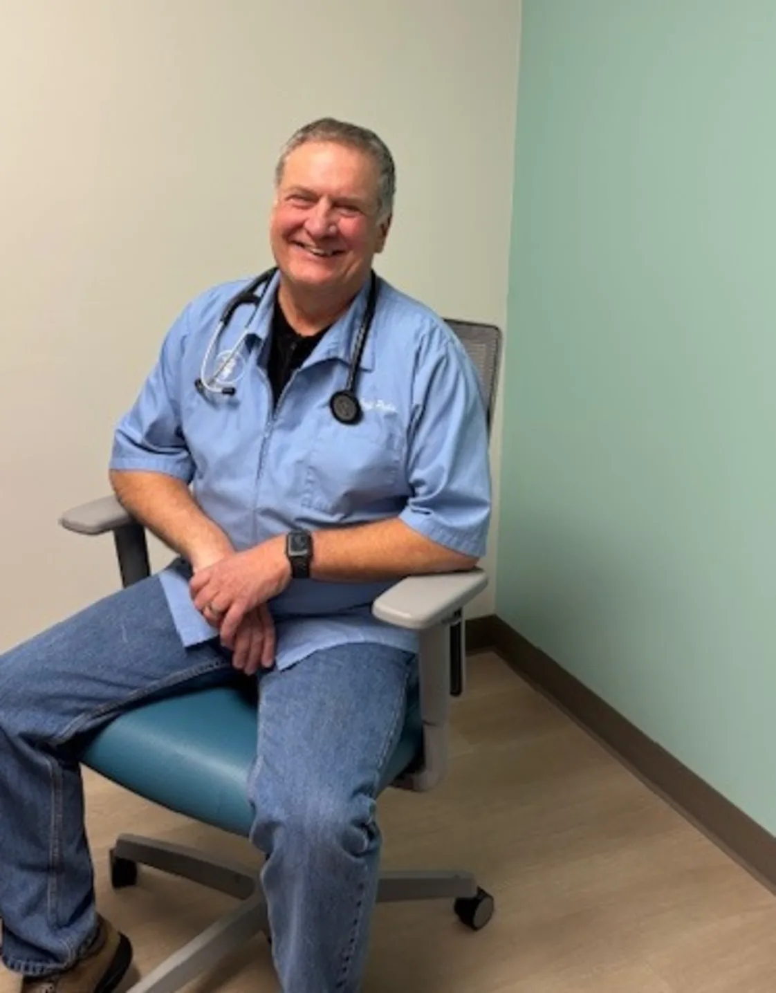 Dr Pelia holding fish in body of water Dr Pelia holding fish in body of water