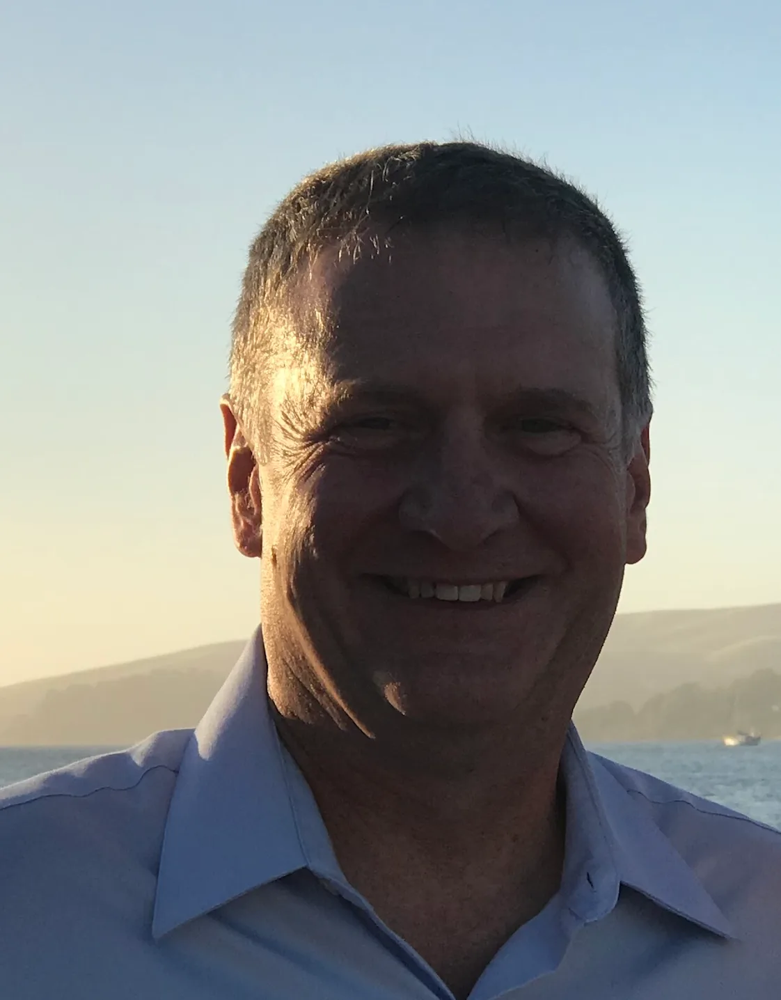 Dr Pelia holding fish in body of water Dr Pelia holding fish in body of water