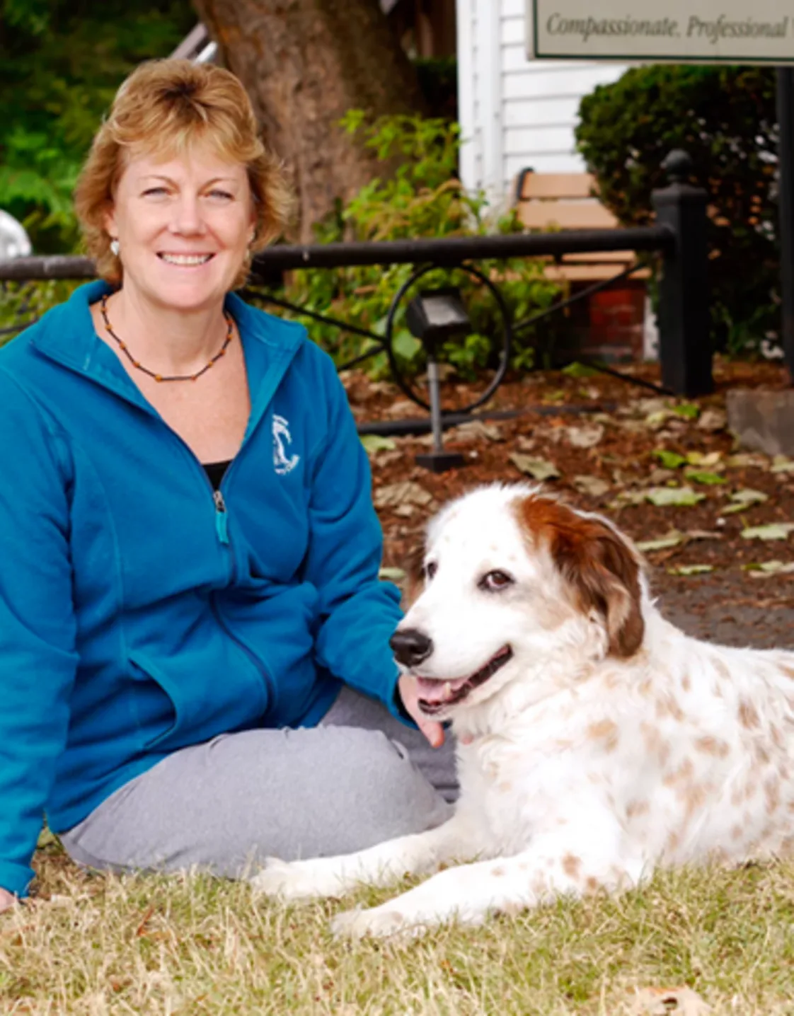 Beverly sitting on the grass with a dog next to her Beverly sitting on the grass with a dog next to her