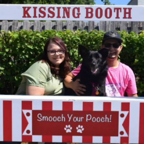 Staff Members Working at a Dog Kissing Booth Staff Members Working at a Dog Kissing Booth