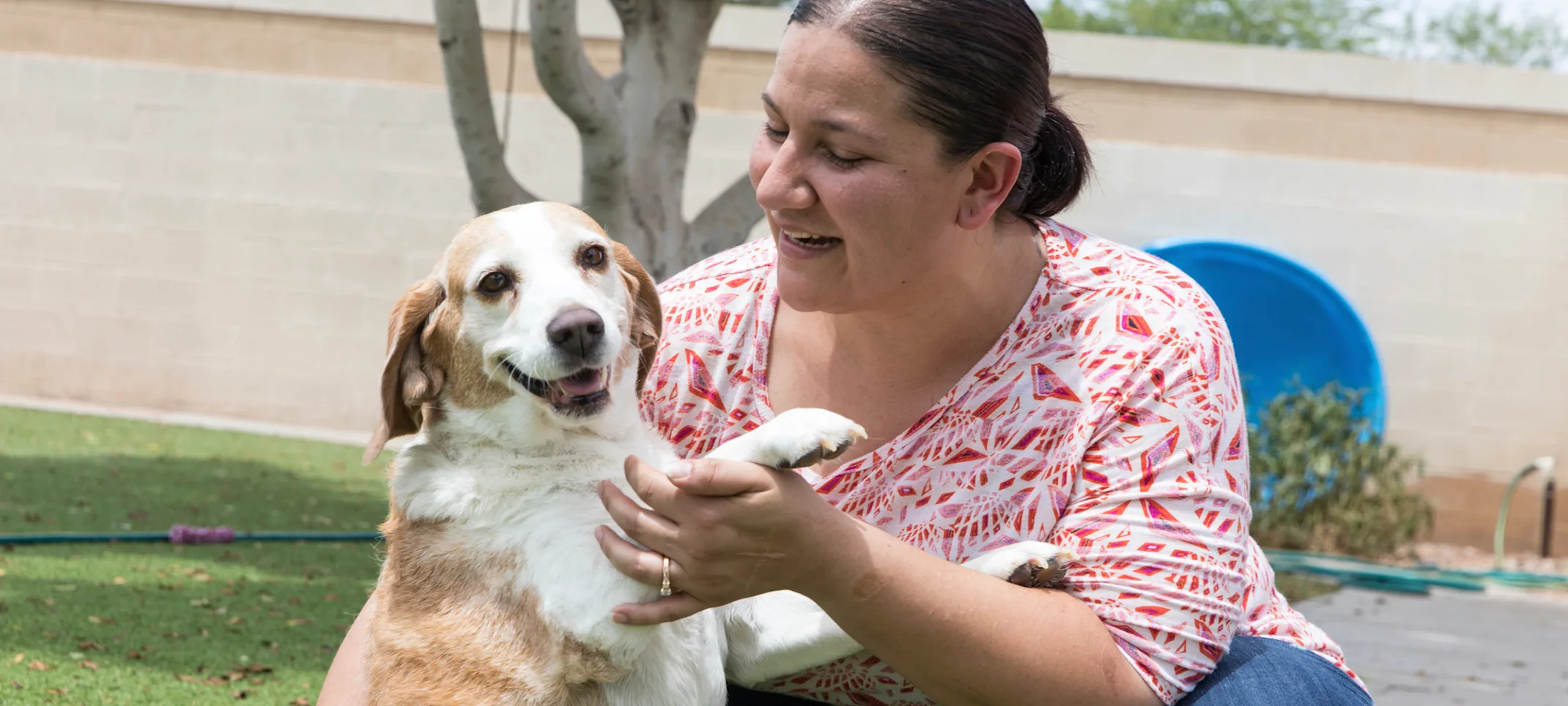 Happy dog with staff member at 4 Paws Pet Resort Happy dog with staff member at 4 Paws Pet Resort
