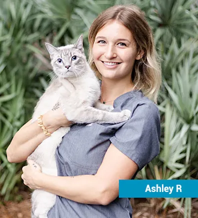 Staff member with white cat Staff member with white cat