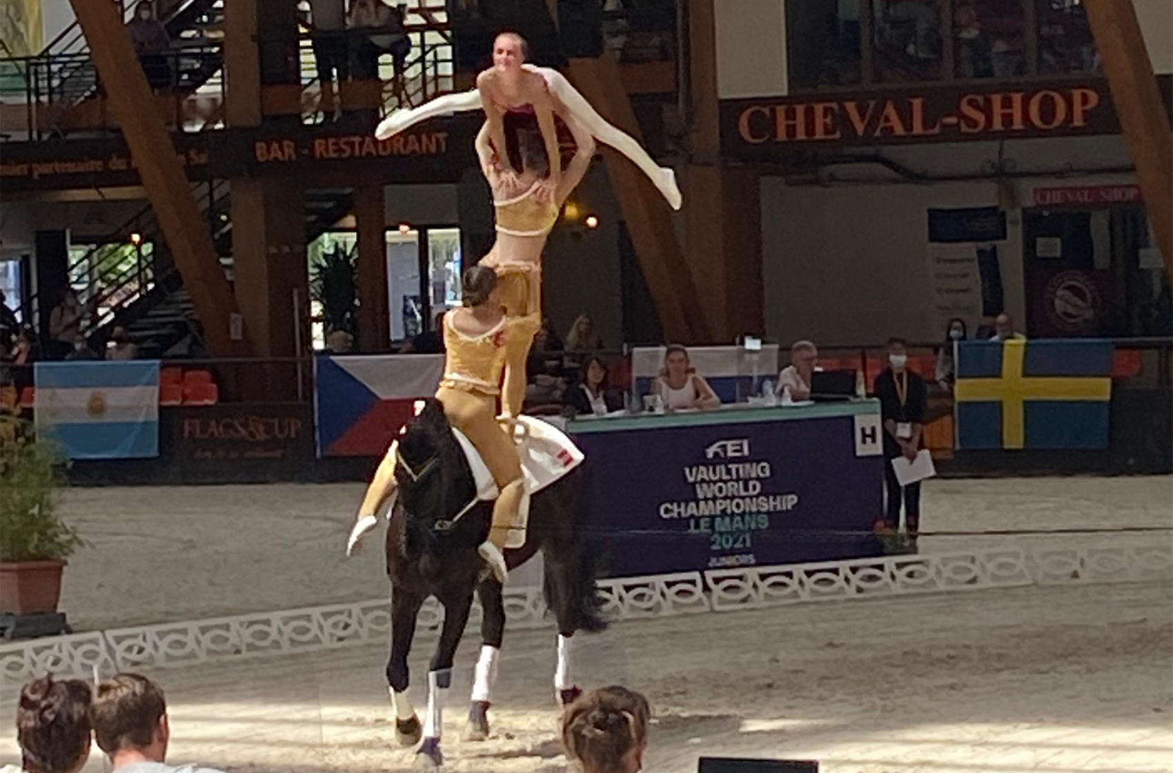 Three girls performing in an equine show
