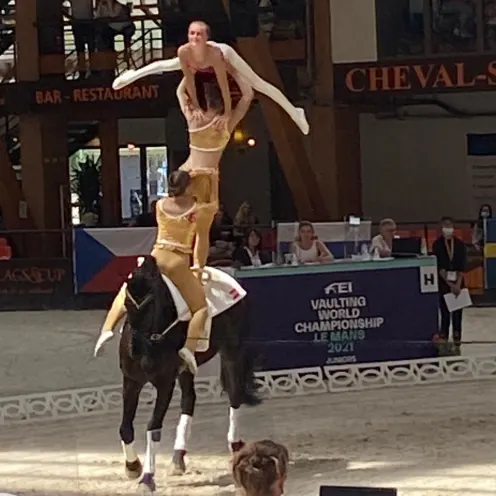 Three girls performing in an equine show