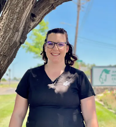 Georgie with a black kitten on her right shoulder Georgie with a black kitten on her right shoulder