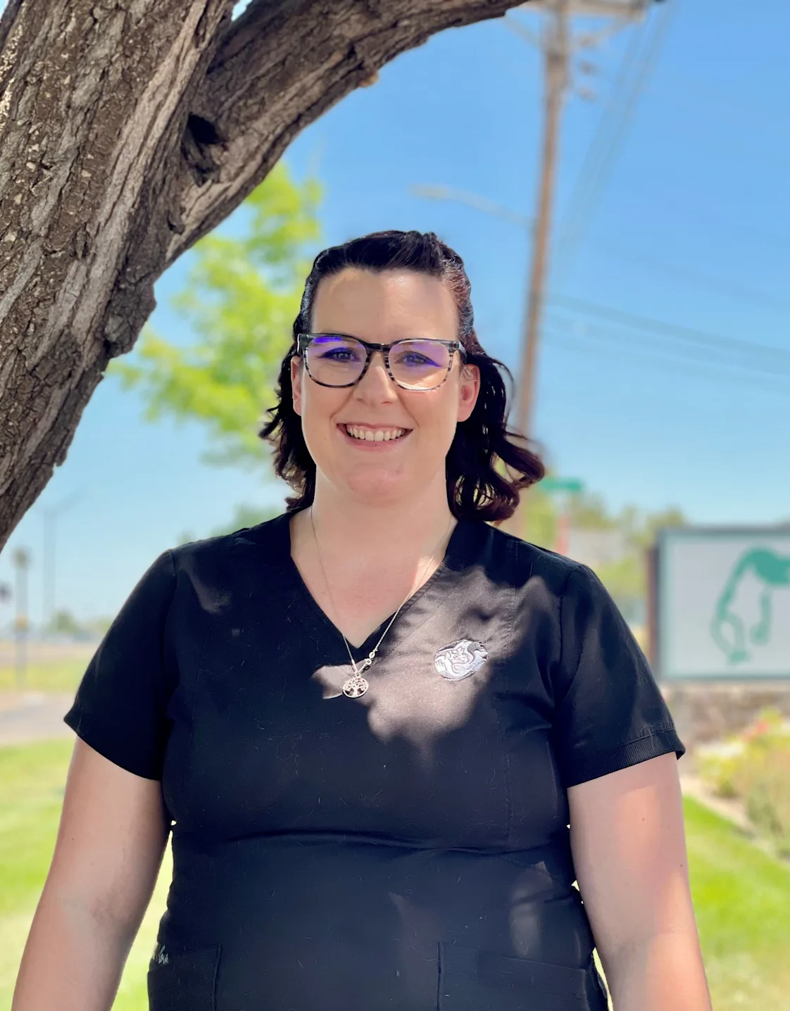 Georgie with a black kitten on her right shoulder Georgie with a black kitten on her right shoulder