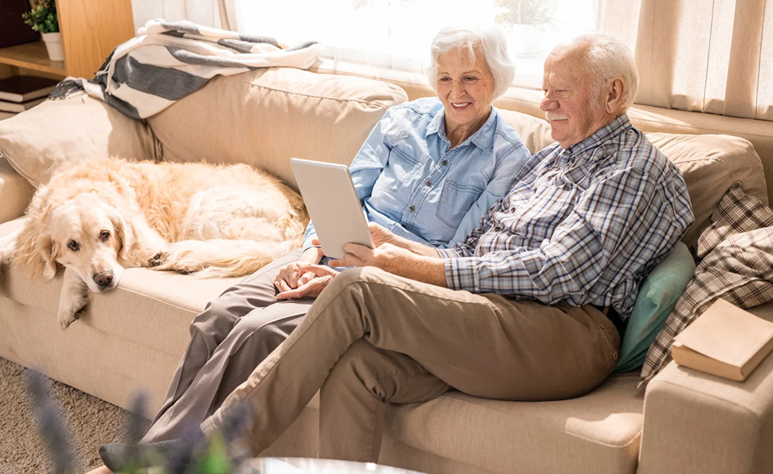 Old couple on couch with a dog