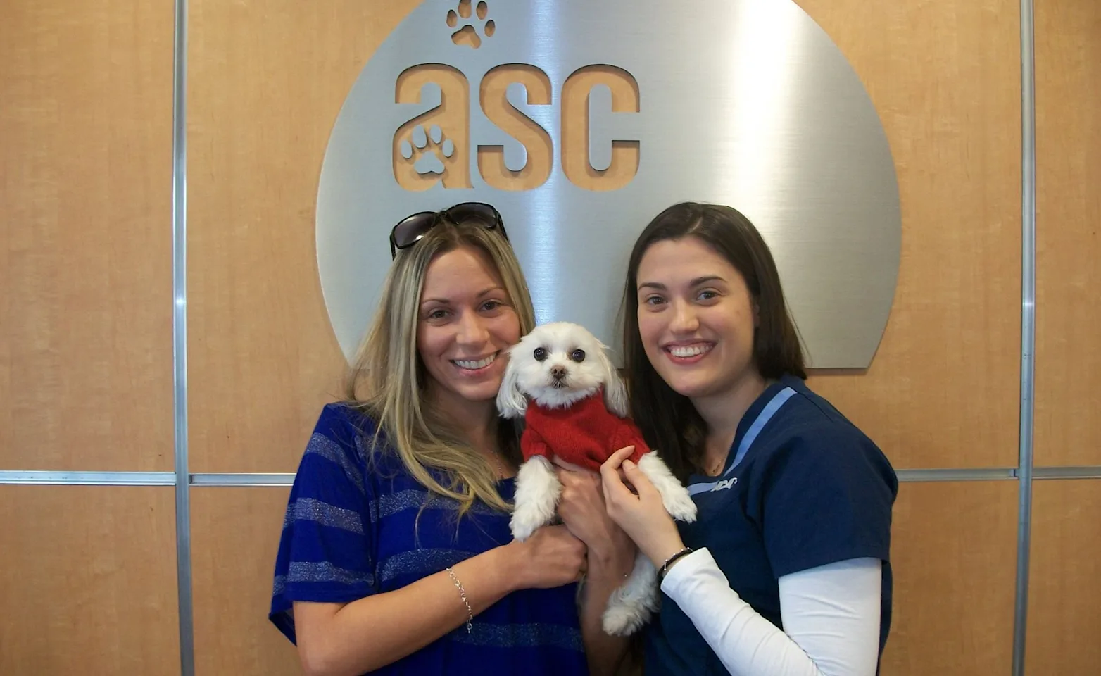 Animal Specialty Center staff with pet parent at event Animal Specialty Center staff with pet parent at event