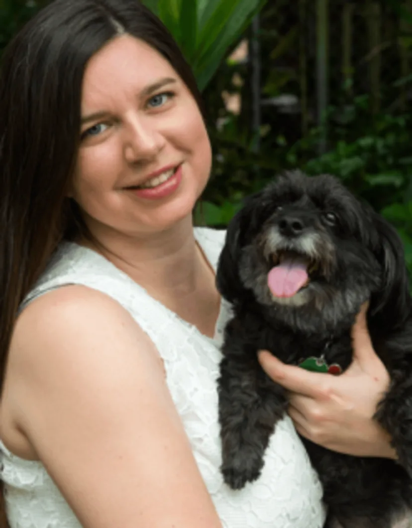 Mary Brewington holding a small black dog