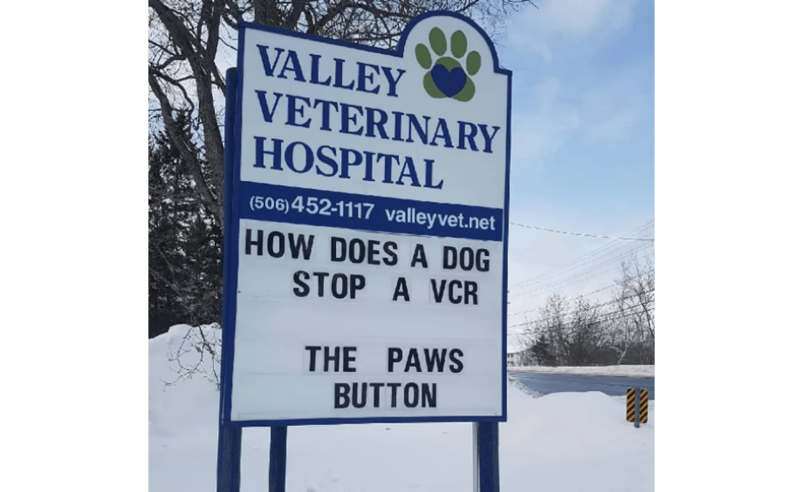 The hospital sign of Valley Veterinary Hospital with a written joke saying, "How does a dog stop a VCR? The Paws Button" The hospital sign of Valley Veterinary Hospital with a written joke saying, "How does a dog stop a VCR? The Paws Button"