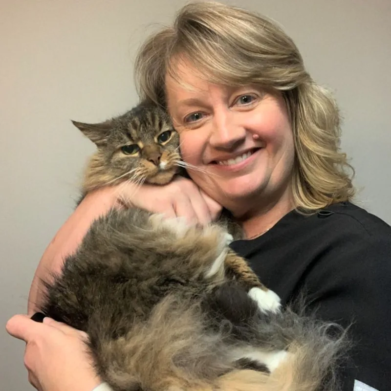 Dr. Elizabeth Patrick, DVM smiling and holding a long haired cat close to her face Dr. Elizabeth Patrick, DVM smiling and holding a long haired cat close to her face