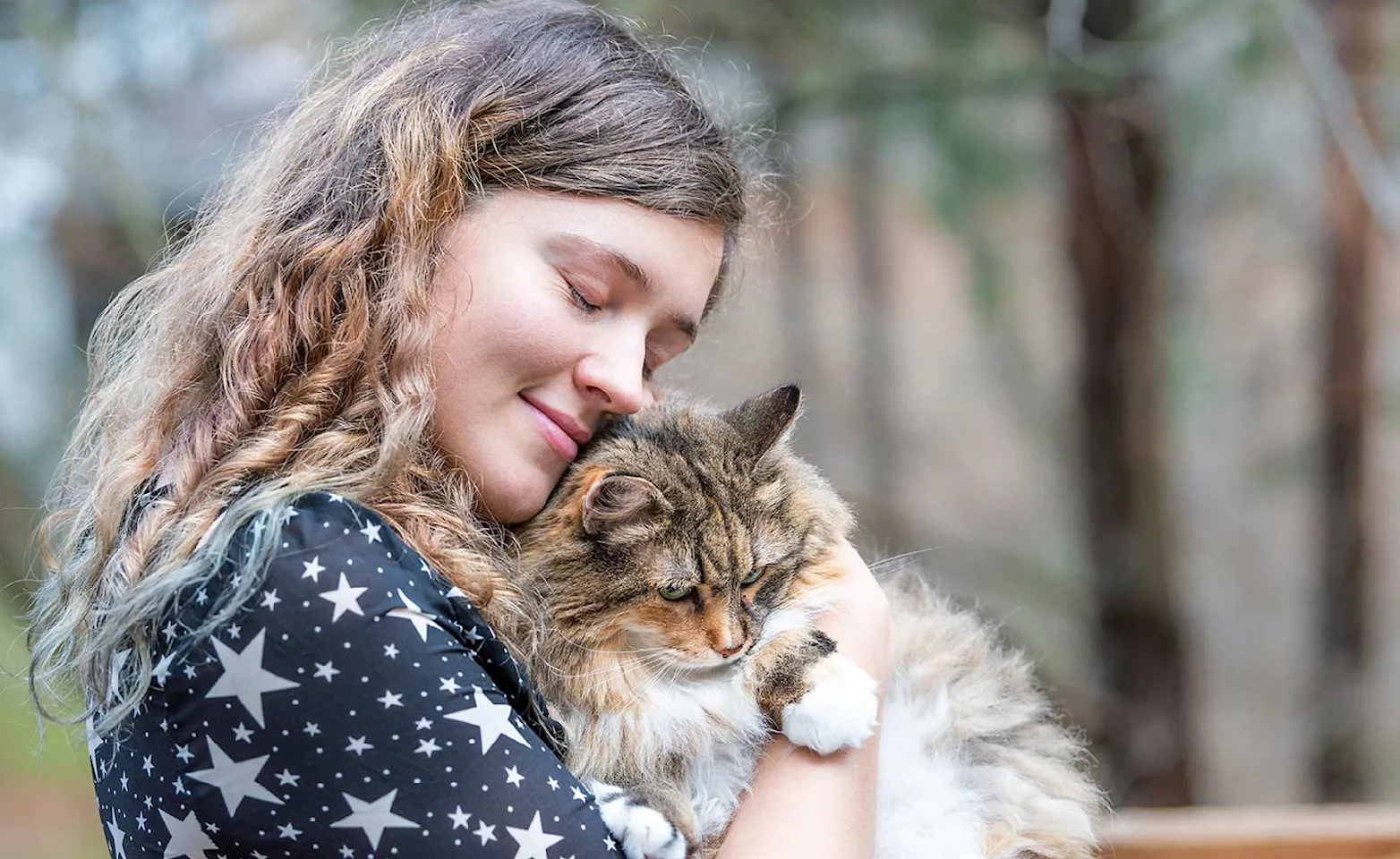 woman hugging cat