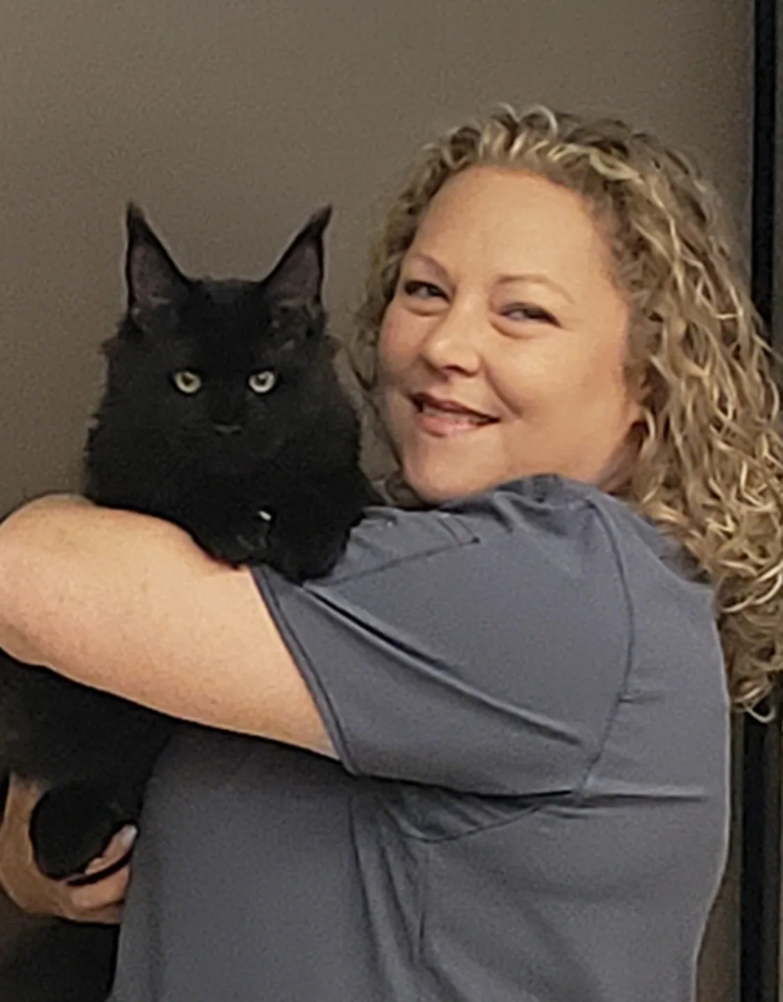 Patty McCullough holding a black cat Patty McCullough holding a black cat