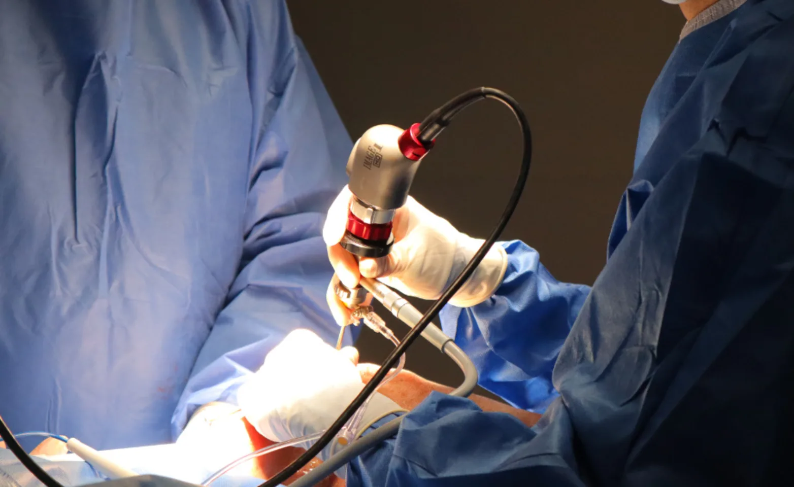 Vet using surgical tool Vet using surgical tool