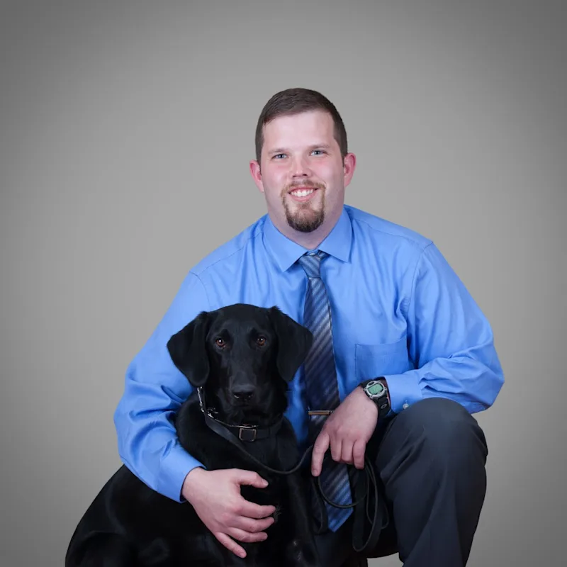Dr. Mark Piechocinski, Veterinarian at Mallard Point Veterinary Clinic, with black dog Dr. Mark Piechocinski, Veterinarian at Mallard Point Veterinary Clinic, with black dog