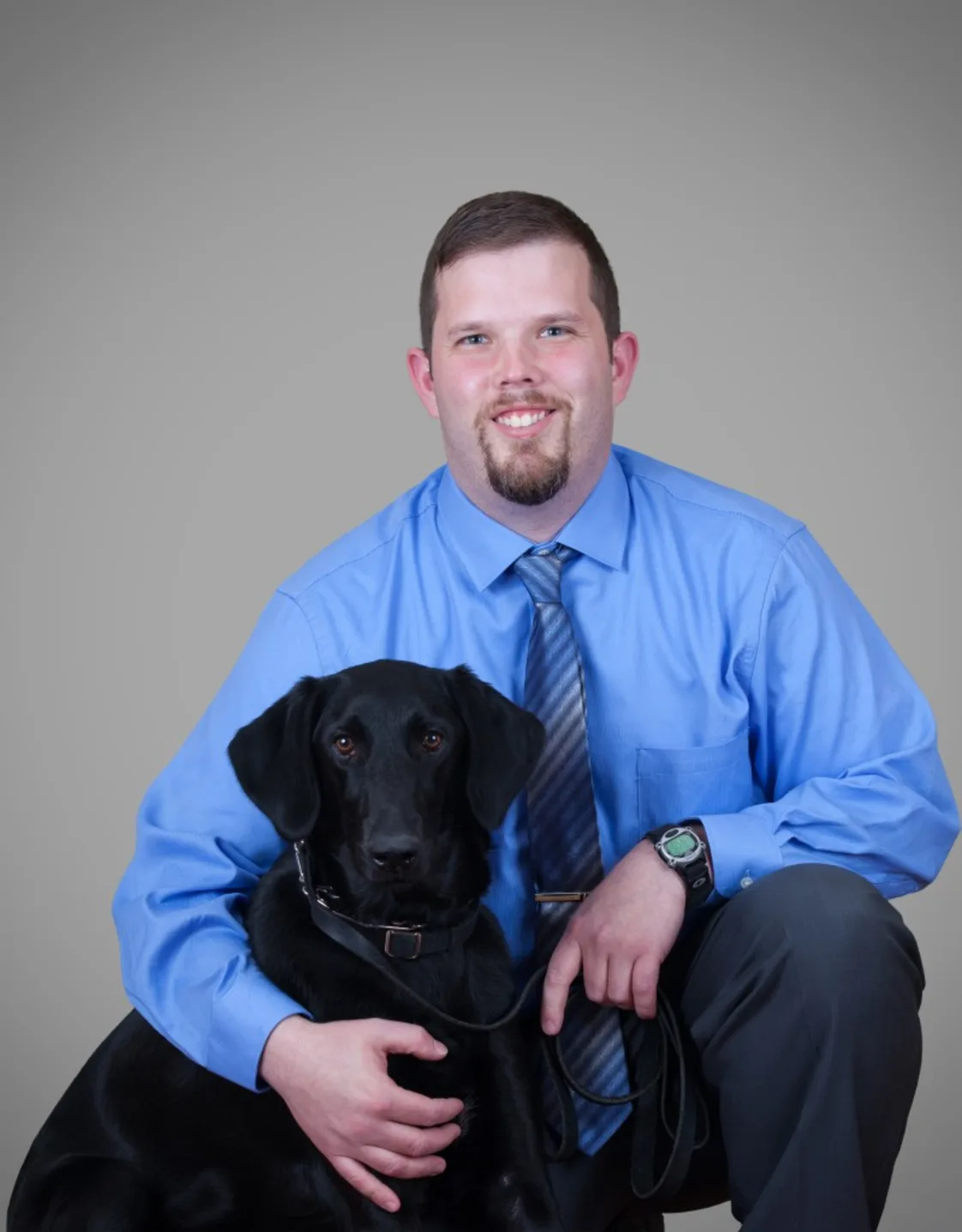 Dr. Mark Piechocinski, Veterinarian at Mallard Point Veterinary Clinic, with black dog Dr. Mark Piechocinski, Veterinarian at Mallard Point Veterinary Clinic, with black dog