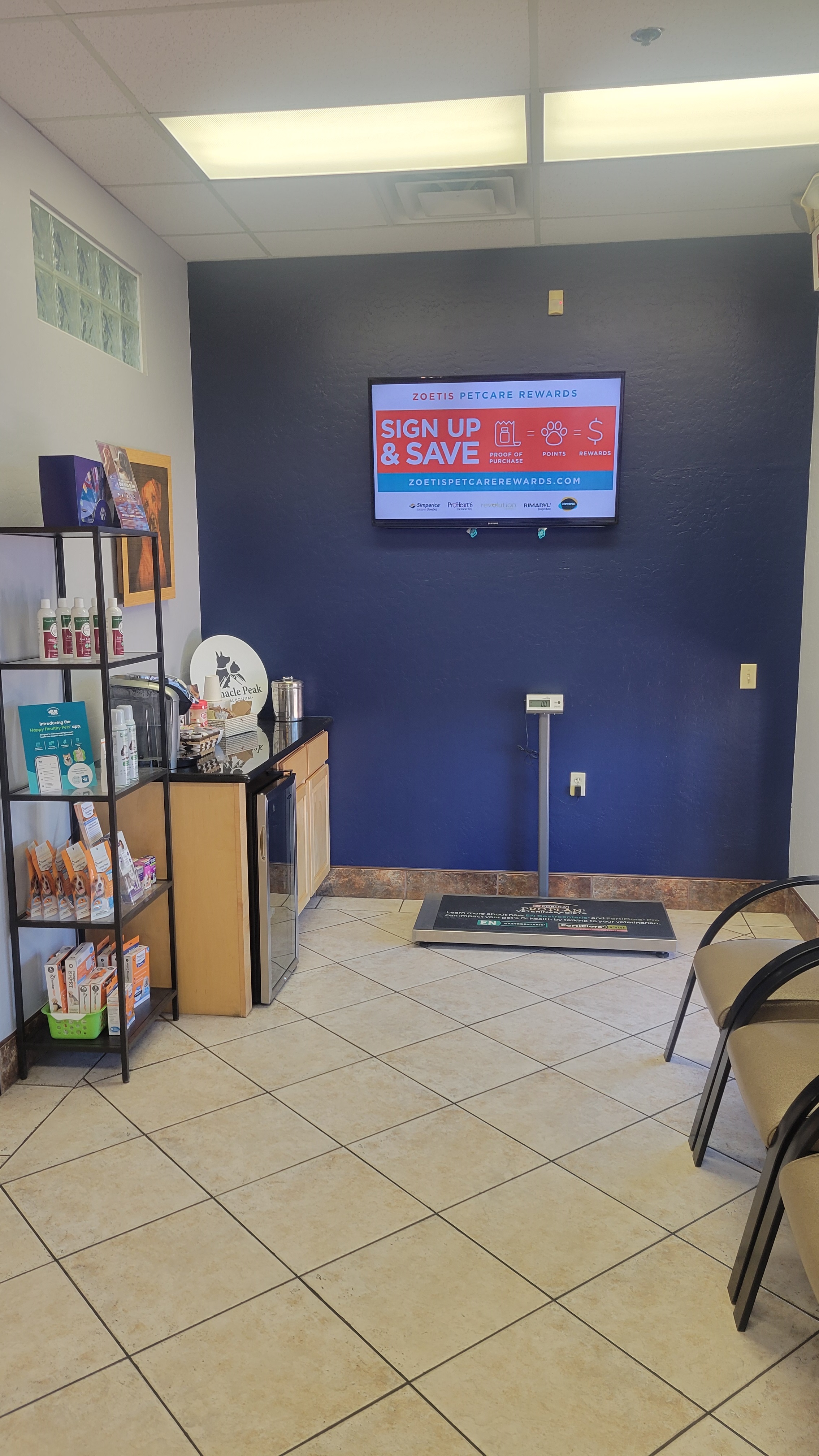 The lobby at Pinnacle Peak Animal Hospital displaying a scale, along with coffee and water bar, and waiting area seats