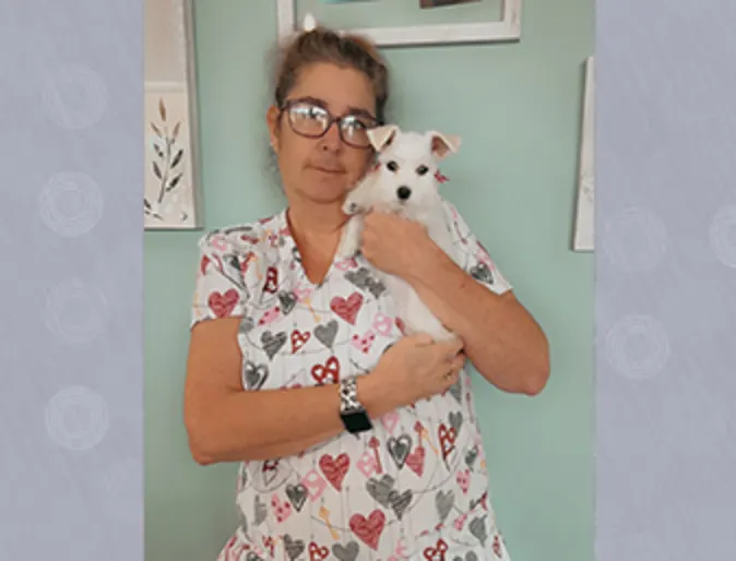 A Gentle Care Animal Hospital staff posing with a dog