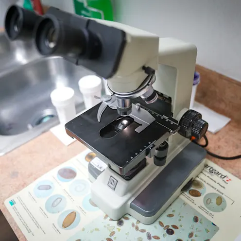 close-up shot of a microscope next to a sink close-up shot of a microscope next to a sink