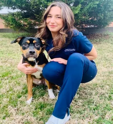 Hailee holding onto a rottweiler puppy. Hailee holding onto a rottweiler puppy.