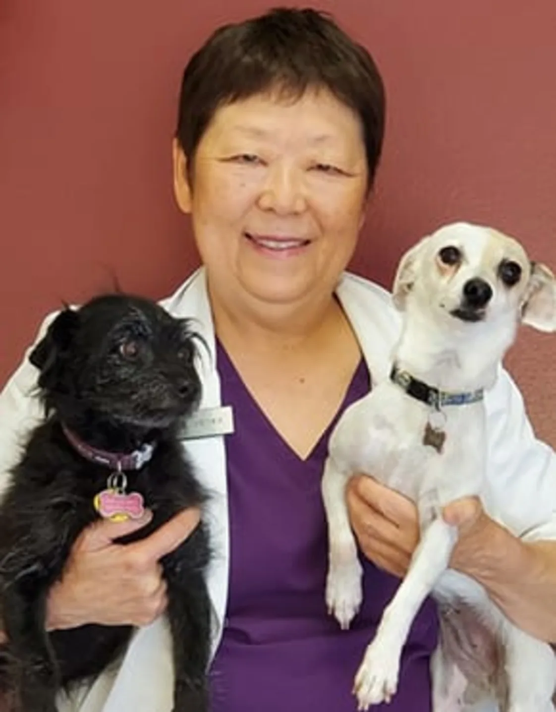 Dr. Lynn Vieyra holding two dogs Dr. Lynn Vieyra holding two dogs