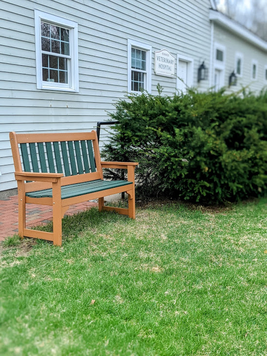 Outdoor sitting bench on lawn at Henniker Veterinary Hospital