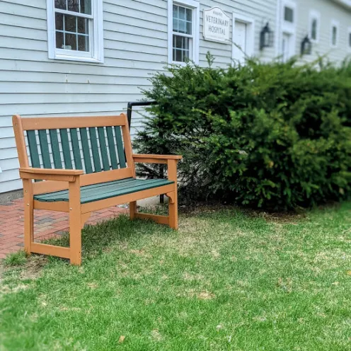 Outdoor sitting bench on lawn at Henniker Veterinary Hospital