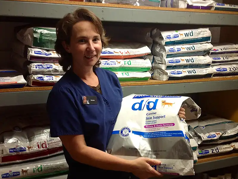 Staff holding dog food