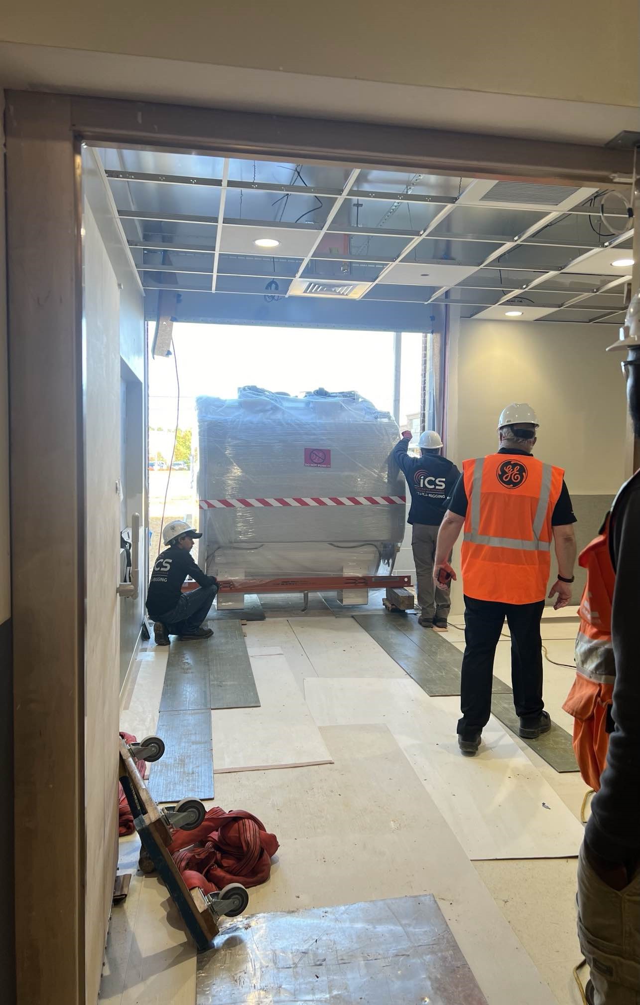 MRI machine being hauled into hospital by construction crew
