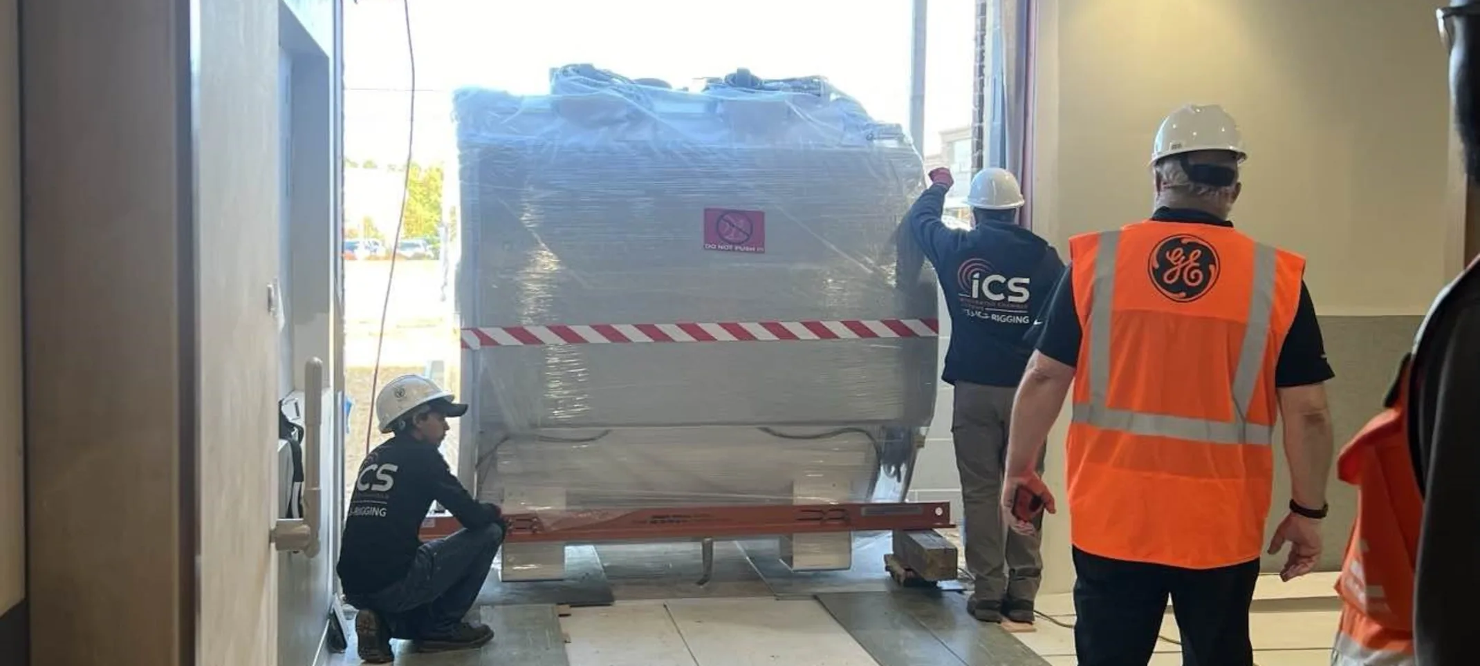 MRI machine being hauled into hospital by construction crew MRI machine being hauled into hospital by construction crew
