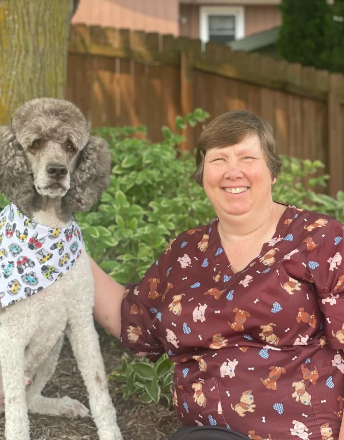 Carol, groomer at Camp K9, with a dog Carol, groomer at Camp K9, with a dog