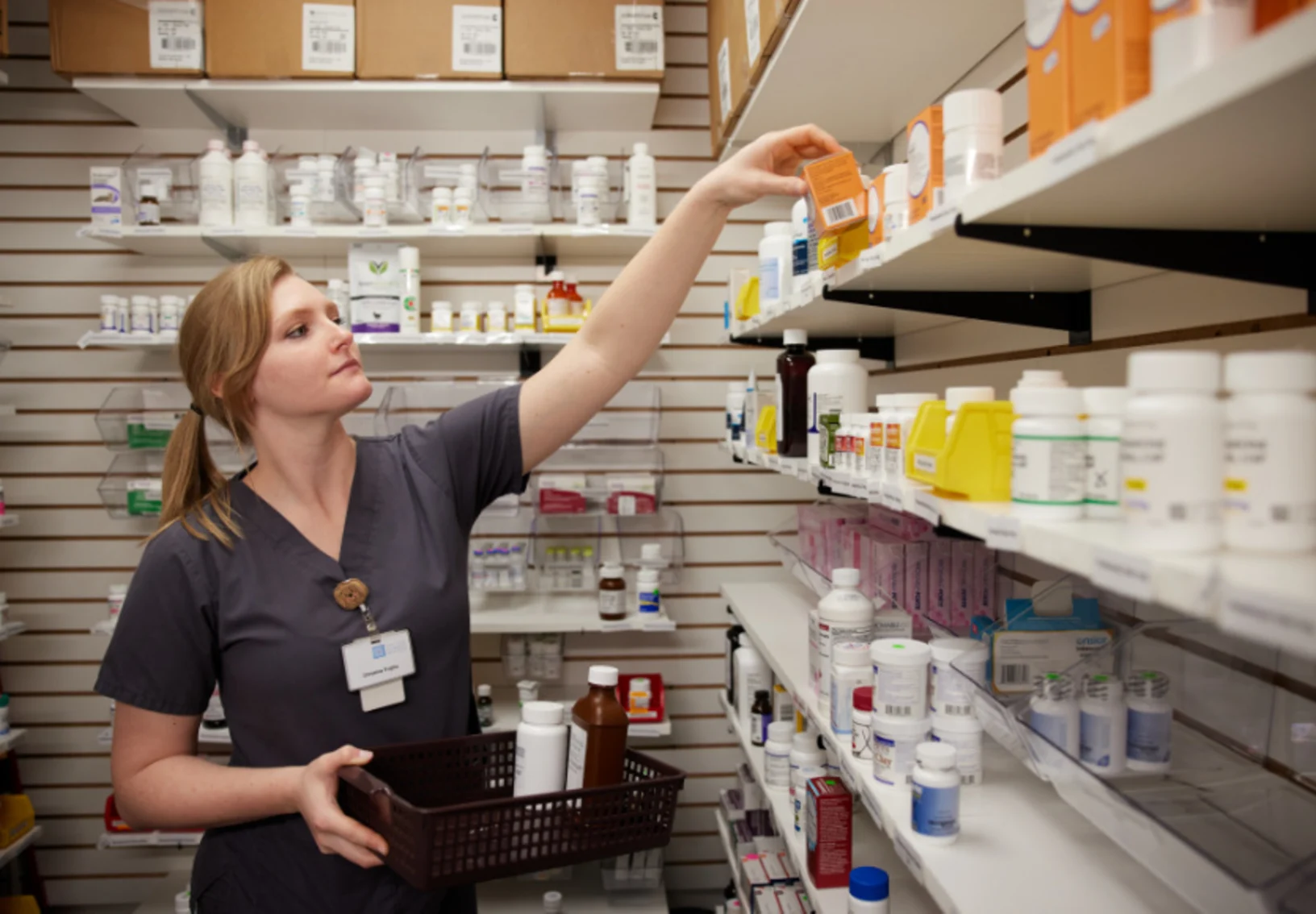 Staff member grabbing medication from shelf Staff member grabbing medication from shelf