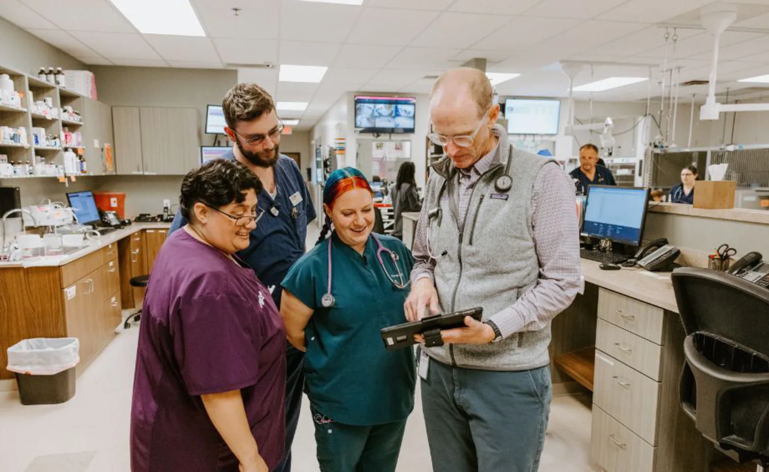 Staff members looking at a tablet Staff members looking at a tablet