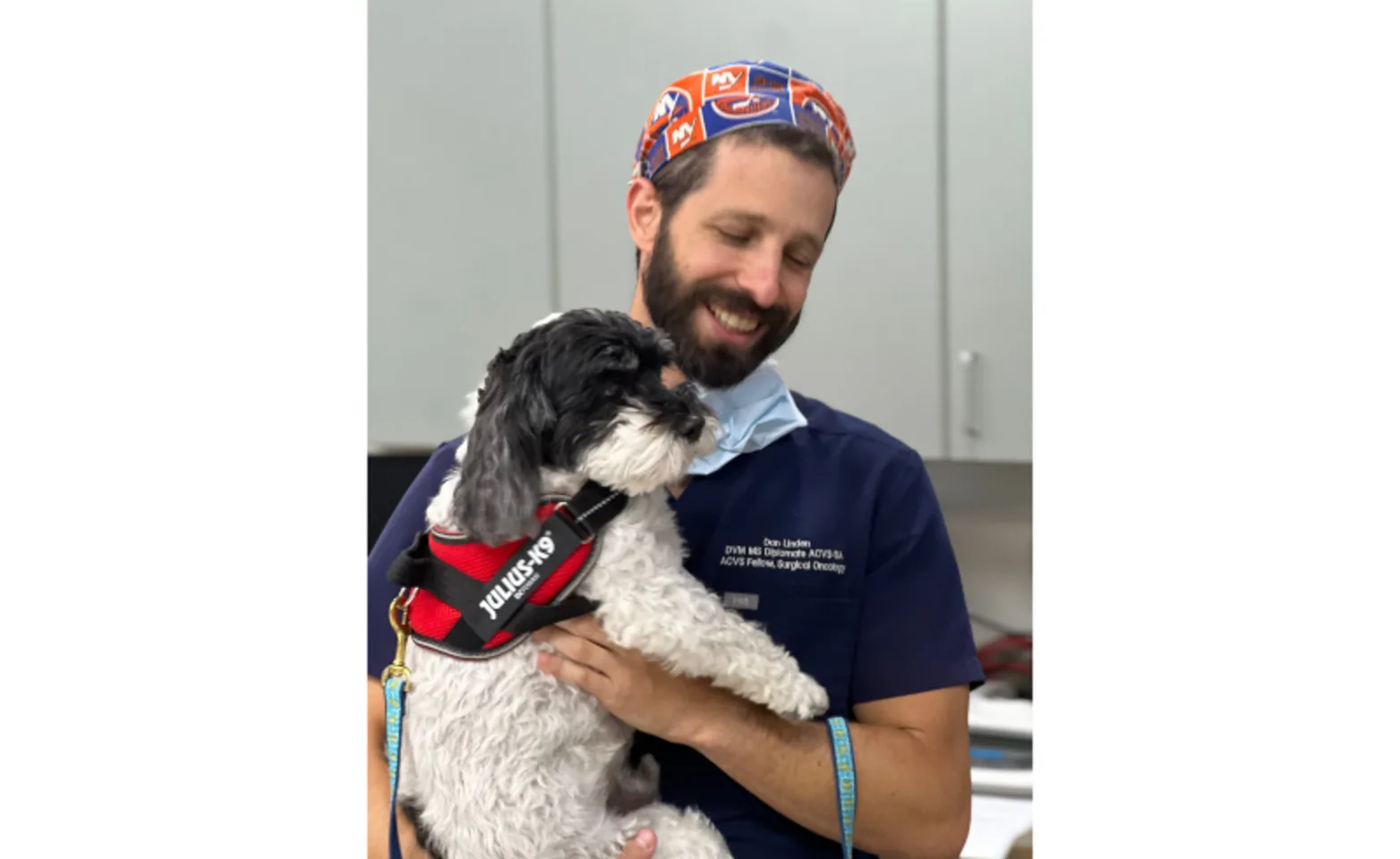 Staff Member Holding Black & White Dog Staff Member Holding Black & White Dog