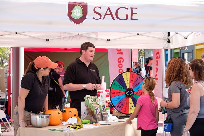 Two Staff Members Providing Information at SAGE Booth