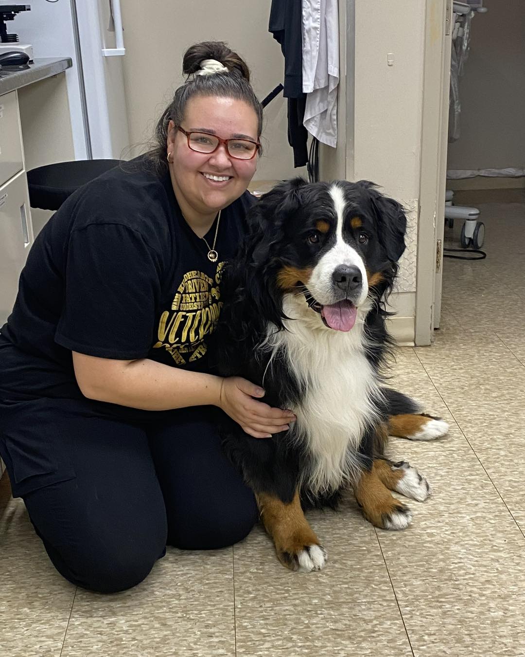 dog laying in a vet lap